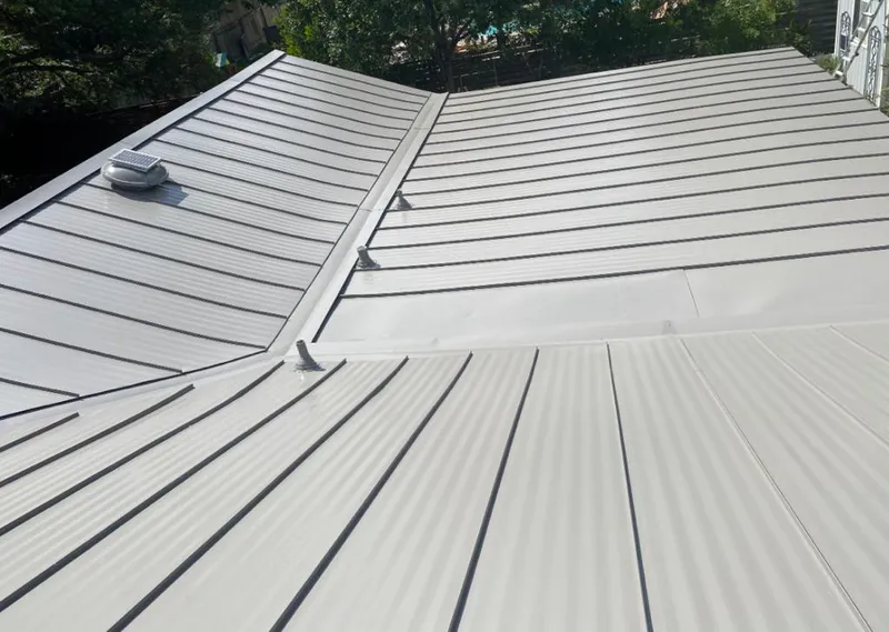 Solar attic fan installed on a metal roof for Roof Ventilation in Miami Shores